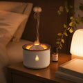 Flame aroma diffuser glowing warm on a nightstand with a mist plume