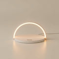 Mizuvo arc LED lamp in white, three-quarter view, warm glow