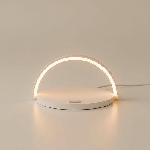 Mizuvo arc LED lamp in white, three-quarter view, warm glow